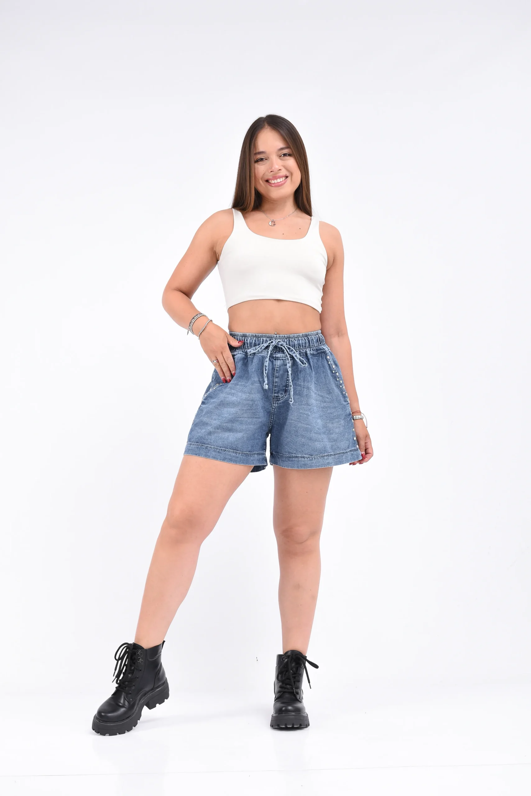 Plano entero de modelo luciendo short de jean azul oscuro tiro alto con cintura elastica Chio